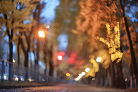 Evening in an autumn park, abstract blurred background, changing seasons in the city