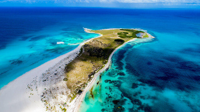 Aerial view of Los Roques archipelago with white sand beaches, turquoise Caribbean waters, and lush vegetation Los Roques, Dependencias Federales, Venezuela.