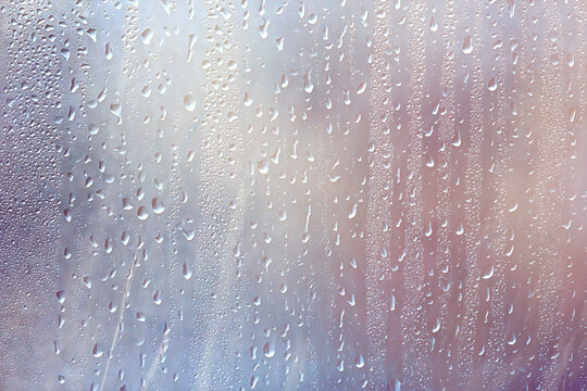 background of rain drops on glass, abstract summer grass and flowers in wet nature freshness