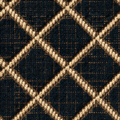 Obraz premium Seamless pattern navy blue fabric texture showing a diamond pattern with interwoven light beige ropes, providing a sophisticated textile background