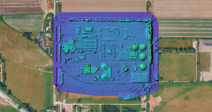 Aerial view of an industrial facility with circular tanks and processing structures rendered as a 3d model, surrounded by agricultural fields in Richmond, British Columbia, Canada.