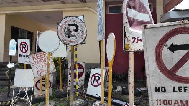 Traffic and parking signs stored outdoors, Dumaguete, Philippines