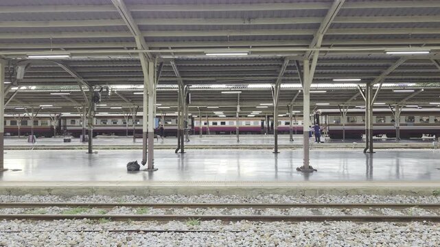 Passenger train departing from Hua Lamphong Railway Station in Bangkok, Thailand, captured as the train moves through the covered platforms. BKK, Thailand. 22 Sep 2026