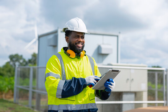 Engineer smiles while reviewing data on tablet