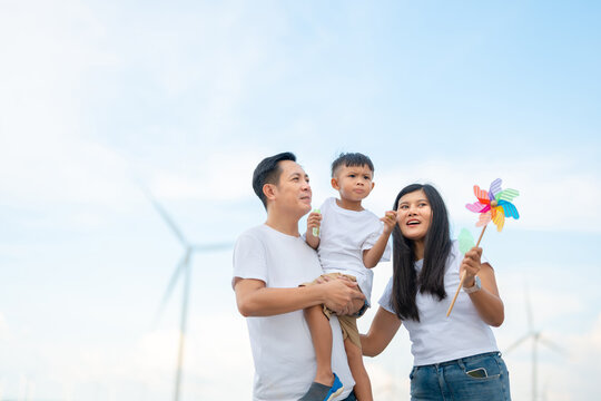 Family smiles under bright sky