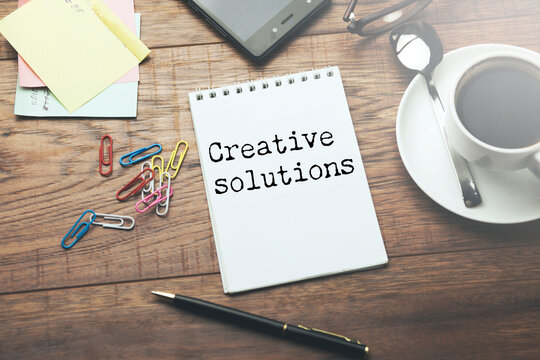 Creative solutions text on paper