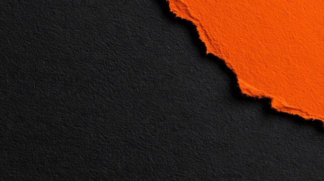 A minimal Halloween background combines smooth charcoal paper with one torn orange corner revealing a deeper black layer beneath, creating a simple graphic composition