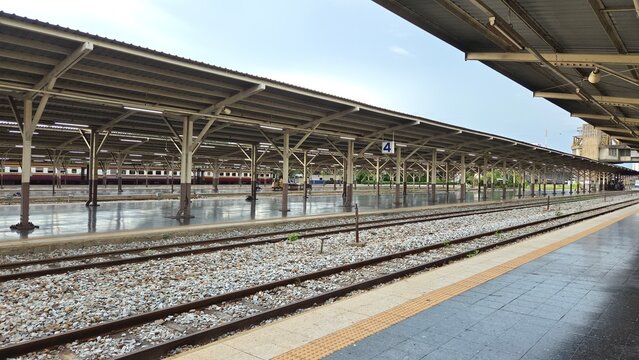 Wide view of railway tracks and covered platforms at Hua Lamphong Railway Station in Bangkok, Thailand, with a passenger train in the background. BKK, Thailand. 22 Sep 2026