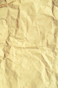 Texture background of crumpled brown kraft paper with deep creases and rough wrinkled surface