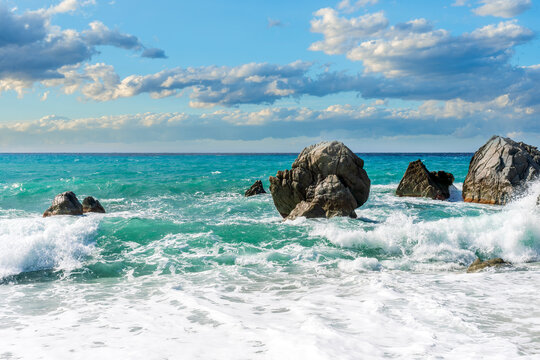 Dramatic seascape on golden sand coast with clouds during morning or evening. Dramatic day over the sea with blue clouds and turquiose sea surf