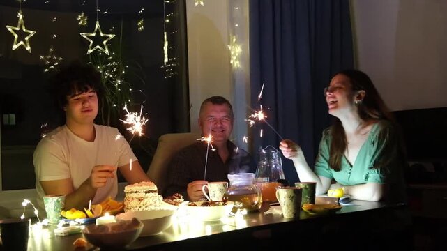 Celebration with family using sparklers at home during a special event