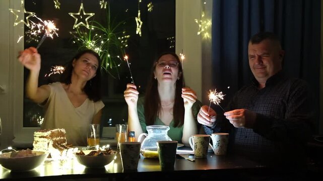 Celebration with sparklers and friends at home in the evening near