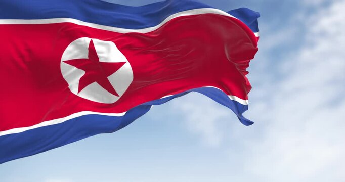 Close-up of North Korea national flag waving in the wind on a clear day