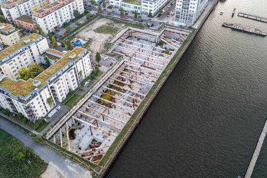 Aerial view of the construction site near the Treptowers with steel support struts in the excavation pit, adjacent residential buildings, and the Spree river in Berlin, Berlin, Germany.