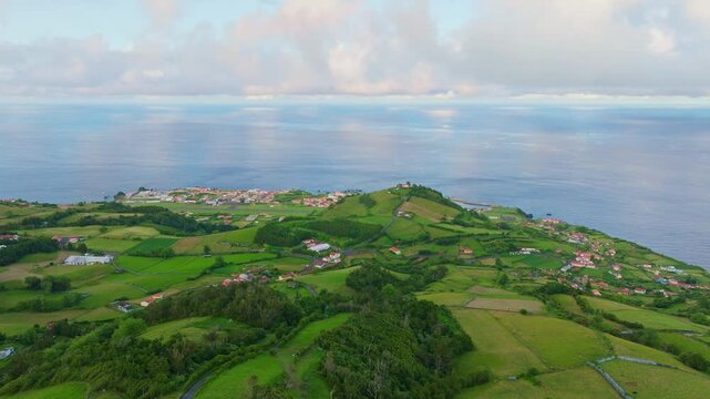 Green rolling hills, pastures, and agricultural fields. Atlantic Ocean. Aerial View. Santa Cruz das Flores airport, Flores, Azores