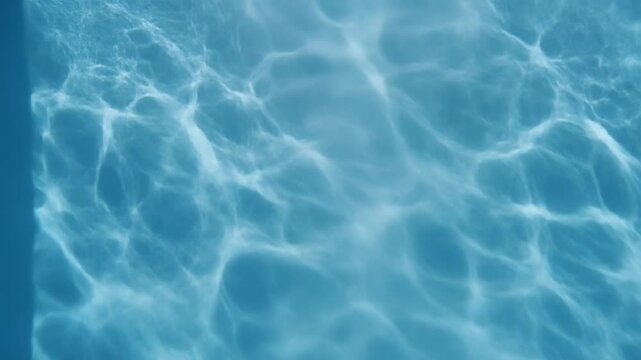 Sunlight dancing on water surface with gentle ripples creating abstract patterns