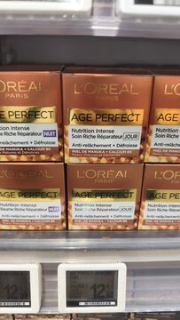 Royan, France - July 25, 2026: E.Leclerc ROYAN CEDEX. L'Oreal Paris Age Perfect skincare products displayed on a retail shelf with price tags and packaging visible in a store environment