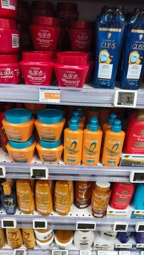 Royan, France - July 25, 2026: E.Leclerc ROYAN CEDEX. Hair care products displayed on supermarket shelves including L'Oreal, Gliss, and various conditioners and shampoos in colorful packaging