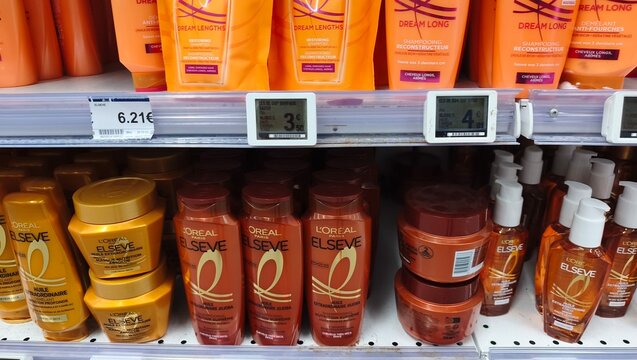 Royan, France - July 25, 2026: E.Leclerc ROYAN CEDEX. L'Oreal Elseve hair care products displayed on a retail shelf, featuring various shampoos, conditioners, and treatments in orange packaging