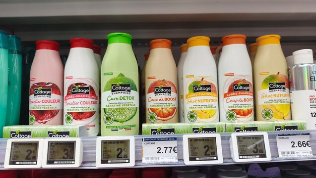 Royan, France - July 25, 2026: E.Leclerc ROYAN CEDEX. Bottles of Cotage shampoo displayed on a retail shelf with price tags and colorful packaging in a supermarket aisle