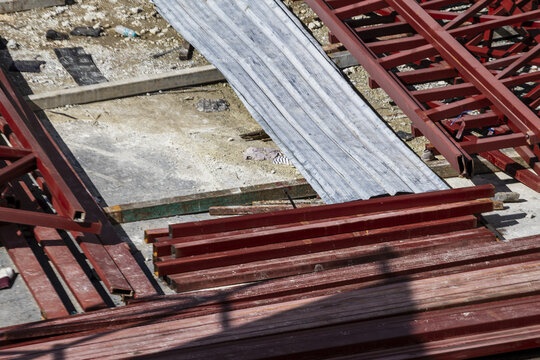 Steel beam construction site metal industrial red structure outdoor building horizontal shadow unfinished framework daytime architecture equipment material engineering urban development ground