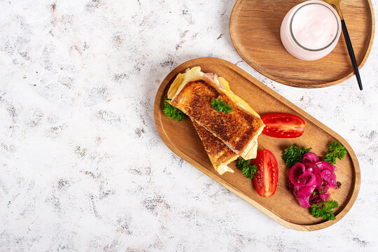 Croque Monsieur Style Sandwich with Ham and Melted Cheese and yogurt. Top view