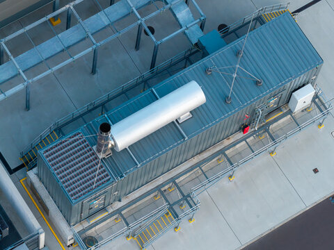Aerial view of an advanced data center facility with industrial cooling units, metal structures, and concrete flooring in Warsaw, Masovian Voivodeship, Poland.
