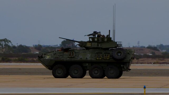armored tank vehicle driving on an airstrip during demonstration