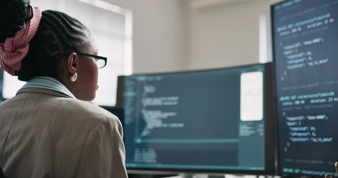 Woman, screen and code with computer for programming, script and update firewall for cybersecurity. Back, programmer and coding in office with tech, debugging system and testing for data protection