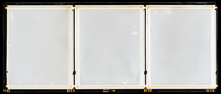 Three blank overexposed medium format film frames arranged in a row on a contact sheet
