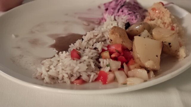woman in restaurant with Plate with Brazilian churrascaria side dishes including white rice, roasted potatoes, fresh tomato salsa, colorful accompaniments, reflecting a traditional dining experience