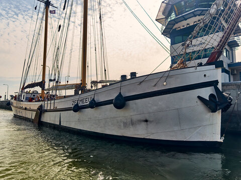 Traditional sailing barge in the Lorentz sluice at Kornwederzand, historic tall ship moored in the Netherlands for maritime heritage and tourism travel