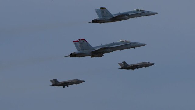 F-35 and F-22 fighter jets taking off from an airfield