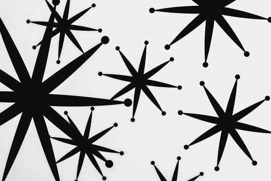 Black Starburst Shapes Arranged on Plain White Background
