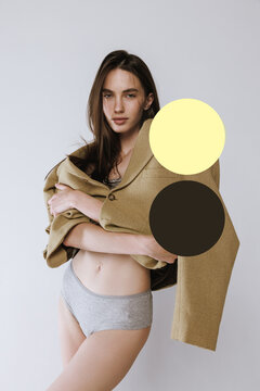 Brunette posing in studio with confident gaze beside yellow and brown graphic circles. Body confidence, fashion styling, self acceptance concept.