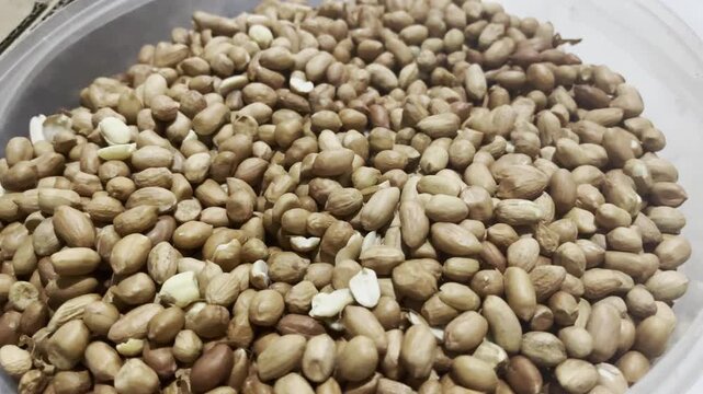 Heap of peeled peanuts background for healthy snack commercial