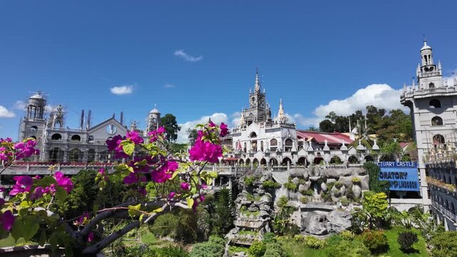 Simala Shrine framed by bougainvillea flowers in Cebu