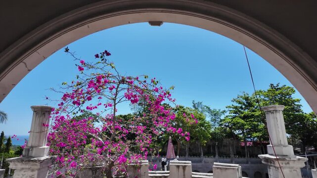 Archway framing bougainvillea flowers at Simala Shrine, Cebu