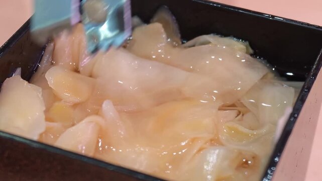 Pickled ginger in a bowl, a popular sushi accompaniment.