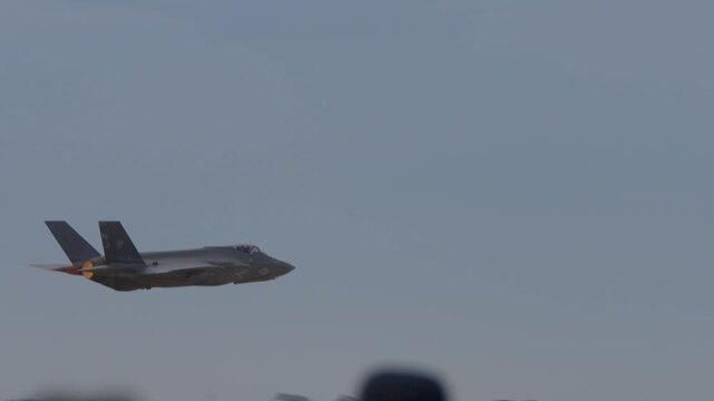 F 35 doing a low takeoff with its afterburner glowing orange