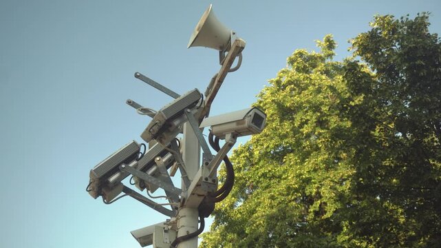 Surveillance Security Cameras on a Pole in a Public Park.Panoramic Movement Around