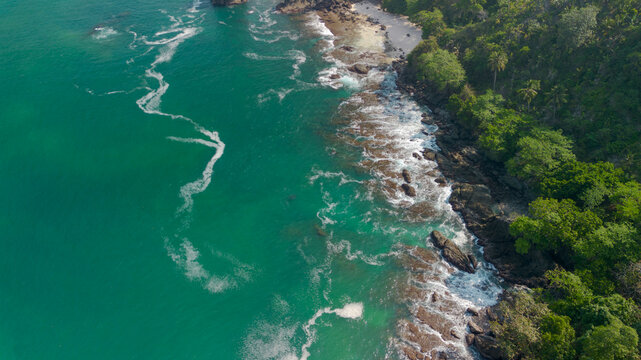 Aerial view of Wedi Awu beach bay with turquoise ocean and lush green hills in Malang East Java