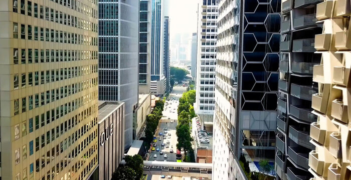 Singapore, Singapore - 30 September 2026: Aerial view of the dense urban street canyon in the Central Business District of Singapore, featuring modern skyscrapers and traffic below.