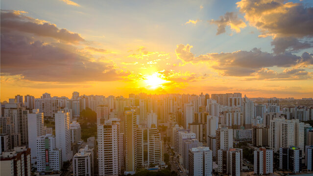 Brasilia, Brazil - 12 September 2026: Aerial view of the modern skyline of Brasilia at sunset with golden light reflecting on the residential high-rise buildings.