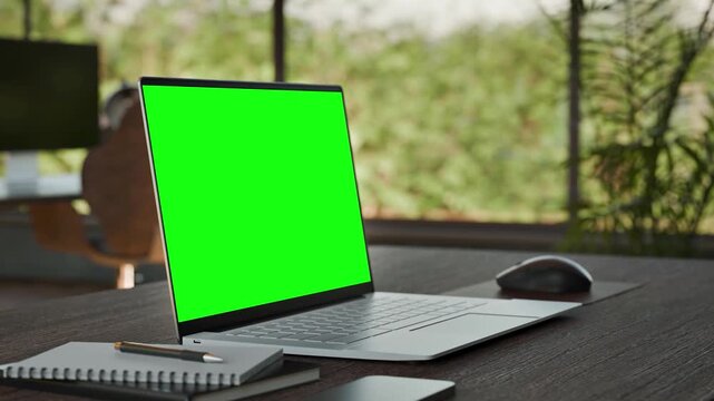 Laptop PC  Blank Green Screen on Desk in Bright Bophilic Office