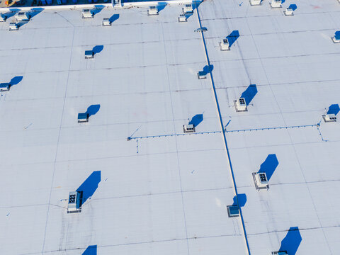 Wilmington, North Carolina, United States - 27 September 2026: Aerial view of the Amazon Robotics Fulfillment Center ILM1 roof, featuring HVAC units casting sharp shadows.