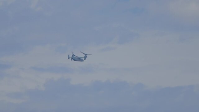 Military osprey flying with vertical propellors