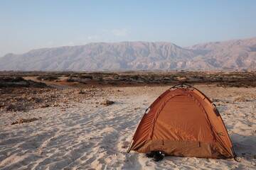 Desert Camping Tent with Rugged Mountains in Oman © fujitoey