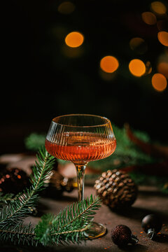 Elegant Rose Champagne Glass with Christmas Decorations and Golden Bokeh