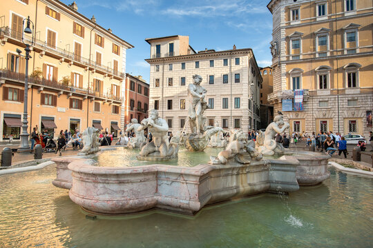 View of the Fontana del Moro in Piazza Navona with its ornate marble sculptures, clear water, and surrounding historic buildings in Rome, Lazio, Italy.
